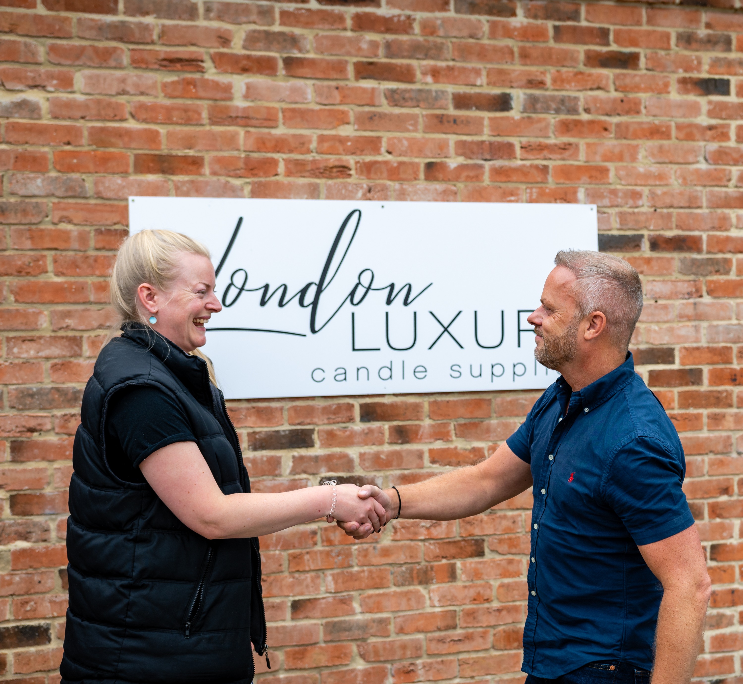 Victoria, from London Luxury Candle Supplies, shaking hands with a customer.
